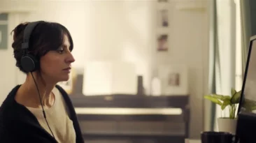 Woman watching a crocodile documentary in café scene from Cocodrilo 2019 short film