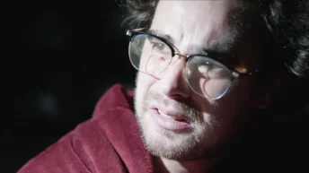 Scene from What We Found Out There 2021 showing hikers encountering terror in the woods
